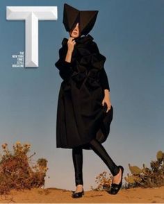 a woman in black is walking on the cover of t magazine