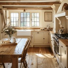 a rustic kitchen with wooden floors and white cabinets, an old - fashioned stove top oven