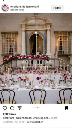 an image of a table set up with flowers and candles in front of a building