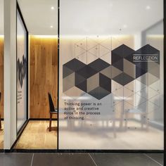 an office lobby with wood and glass walls