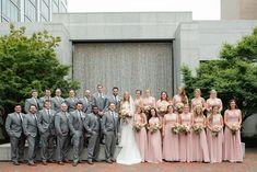 a group of people standing next to each other in front of a building