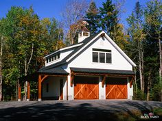 a two car garage in front of some trees