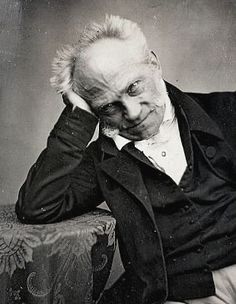 an old black and white photo of a man in a suit sitting on a chair