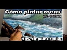 someone is painting rocks in the ocean with their hands and writing that reads, como pintar rocas en el mar how to paint rocks