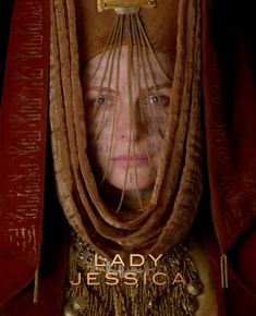 lady jesica is hiding in the curtain with her head covered by gold chains