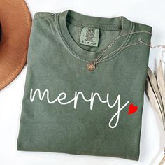 Merry Christmas Comfort Colors T-Shirt, Festive Holiday Tee, Festive Holiday Shirt, Cute Heart Merry Christmas Shirt, Christmas Gift Shirt HOW TO ORDER: Review the product images closely. Select your preferred color from the available options. Choose your T-shirt size from the dropdown menu. Customize the design or text color in the personalization box, and refer to the images for color options unless specified otherwise. Choose the number of items you wish to purchase. Add the items to your car Christmas Cricut Shirts, Merry Shirt, Christmas Shirts Vinyl, Christmas Shirts For Women, Cute Christmas Shirts, Merry Christmas Shirts, Holiday Shirt, Cute Heart, Christmas T Shirt