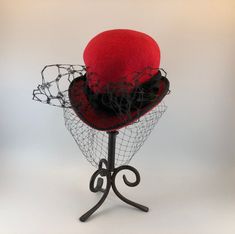 Elevate your fashion game with this exquisite Makshy red heart-shaped cocktail hat fascinator. This accessory is more than just a hat - it's a work of art, expertly crafted by hand in Great Britain. Designed to turn heads, it's the perfect way to add a touch of sophistication and playfulness to any outfit. HAT FEATURES ◦ Unique heart shape achieved through the use of the milliner's own hand-crafted hat block. ◦ Crafted with intricate details and reinforced with millinery wiring to maintain the hat brim's shape over time. ◦ Individually hand-sewn for exceptional attention to detail. ◦ Lined with luxurious silk for added comfort and style. ◦ Custom-made to order for a truly bespoke experience. The fascinator is crafted from high-quality wool felt, renowned for its durability, warmth, and sof Elegant Red Felt Hat For Formal Occasions, Formal Winter Red Felt Hat, Elegant Red Cloche Hat For Winter, Red Fitted Felt Hat For Formal Occasions, Red Fitted Hat For Gift, Elegant Fitted Red Felt Hat, Red Fitted Hat As Gift, Formal Red Fitted Felt Hat, Red Fitted Hats As Gifts