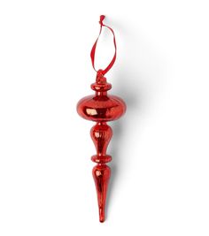 a red glass ornament hanging on a white wall