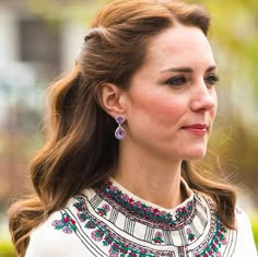 a close up of a person wearing earrings