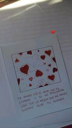 a piece of paper with hearts drawn on it and some words written in red ink