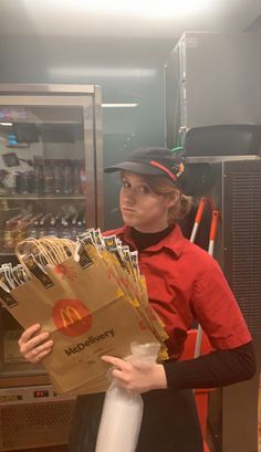 a woman holding a bag full of mcdonald's packets