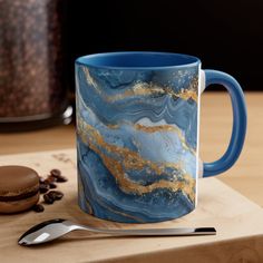 Introducing our Blue Gold Marble Mug: a stunning blend of elegance and style. With its captivating marble design in hues of blue and gold, this mug adds a touch of luxury to your morning routine. Crafted for both beauty and durability, it's perfect for enjoying your favorite beverages in style. Elevate your daily coffee or tea experience with our Blue Gold Marble Mug. Order now and make every sip extraordinary. .: White ceramic with colored interior and handle .: C-handle .: Eye-catching color c Marble Mug, Marble Mugs, Mug Unique, Colored Interior, Gold Marble, Marble Design, Eye Catching Colors, Free Shopping, Blue Gold