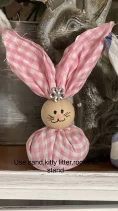 a stuffed bunny sitting on top of a shelf