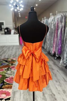 Constructed from luxurious satin material, this homecoming dress features a classic A-line silhouette in a vibrant orange color. The delicate spaghetti straps and tiered ruffle skirt add a touch of elegance, while the above knee length and zip-up back with a bow provide a comfortable and stylish fit. SKU: 3707 Satin material A-line silhouette Orange color Spaghetti straps Tiered ruffle skirt Above knee length Zip-up back with a bow Highly suggest custom size for plus size. Ship in 7-10 business days. We offer free returns in 7 days. Please refer to our return policy page for more details. If you have any questions, don't hesitate to contact us: at service@dressesforparty.com. Orange Hoco Dress, Senior Dress, Corset Layering, Homecoming Inspo, Short Orange Dress, Orange Satin, Tiered Ruffle Skirt, Prom Ideas, Short Homecoming Dress