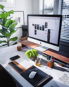 a computer monitor sitting on top of a desk next to a keyboard and mouse pad