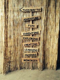 this way to adventure fun exciting creating learning friends memories handmade wooden sign on bamboo background