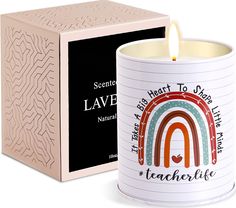 a candle that is in front of a box with a label on it and an image of a rainbow