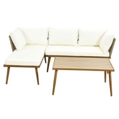 a white couch and coffee table sitting next to each other on a white background,