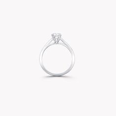 a diamond ring on a white background with the center stone in the shape of a heart