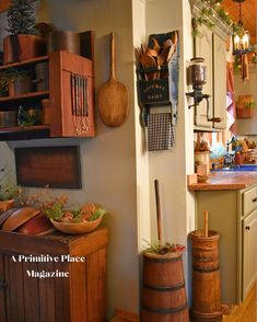 a kitchen filled with lots of pots and pans next to a wall mounted pot rack