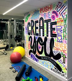 an exercise room with colorful wallpaper and gym equipment