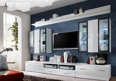 a living room with blue walls and white furniture in front of a flat screen tv