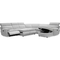 a white leather sectional sofa with recliners on the bottom and one end facing each other