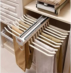 an over the door drying rack in a kitchen with towels hanging from it's sides