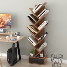 a computer desk with bookshelf in front of a wall mounted tv and monitor