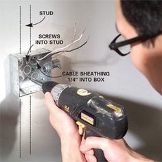 a man is using a cordless drill to fix an electrical outlet on the wall