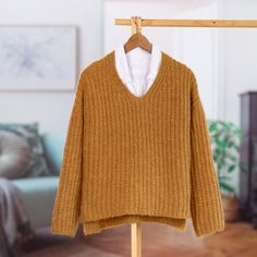 a sweater hanging on a clothes rack in a living room