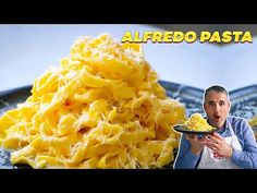 a man holding a plate with pasta on it and the caption alfredo pasta is in front of him