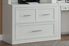 a white desk with two drawers and a printer on top, in front of a brown wall