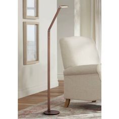 the floor lamp is next to a white chair