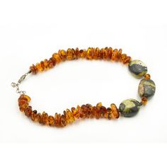 Vintage large freeform baltic honey amber bead necklace featuring sterling silver beaded rondelles as well as an adjustable sterling silver lobster clasp.  The amber is accented by 3 large black and green stones.  The necklace can be adjusted from 17" to 18.40".  The amber beads are approximately .75" wide. Traditional Amber Gemstone Beaded Necklace, Handmade Artisan Amber Beaded Necklace, Antique Amber Gemstone Beads Necklace, Antique Amber Beaded Necklace, Antique Handmade Amber Beaded Necklace, Amber Bead Necklace, Baltic Amber Necklace, Artisan Bracelets, Stone Beaded Necklace