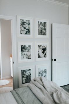 a bedroom with pictures on the wall and a bed in front of two white doors