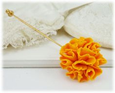 This handcrafted Marigold flower measures approximately 1 inch in diameter. Choice of a silver tone or gold tone stick pin or a brooch pin. -Flower Sze : 1 inch -Pin : Choice of silver tone or gold tone stick pin or brooch pin View matching collection at: https://www.etsy.com/shop/strandedtreasures/search?search_query=marigold Flowers are hand sculpted without molds or paint using polymer clay, a durable water-resistant material. Shop: StrandedTreasures.etsy.com Marigold Wedding, October Birth Flower, October Birth Flowers, October Flowers, Marigold Flowers, Groomsmen Boutonniere, Marigold Flower, Polymer Clay Flowers, Clay Flowers