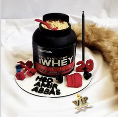 a teddy bear laying on top of a bed next to a jar of whey