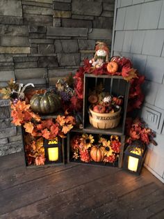 an arrangement of pumpkins, gourds and candles on a porch with fall leaves