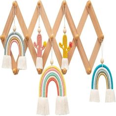 three wooden pegs are hanging on the wall with different colored rainbows and cactuses