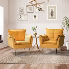 two yellow chairs sitting next to each other in a living room