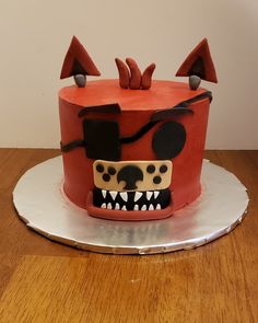 a red cake with black and white designs on it