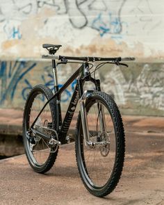 a bike parked in front of a wall with graffiti on it's walls and floor