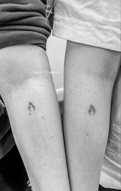 two people with small tattoos on their legs