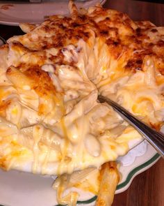 a plate with some food on it and a fork in the middle next to it