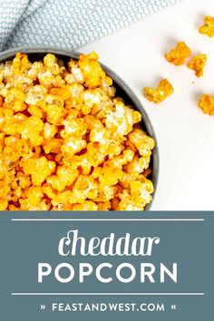 a bowl filled with cheddar popcorn on top of a table