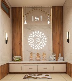 a white and brown room with buddha statues on the wall, lights hanging from the ceiling