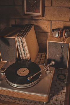 an old record player sitting on top of a table