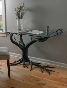 a glass table with some branches on it