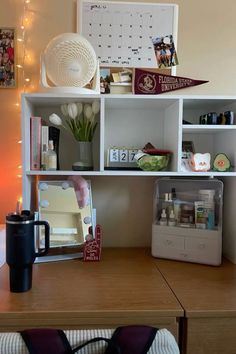 a wooden desk topped with shelves filled with personal items